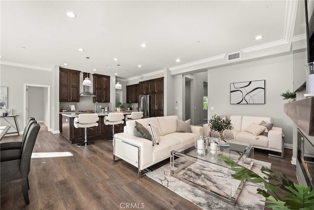 living room featuring dark hardwood / wood-style flooring and ornamental molding