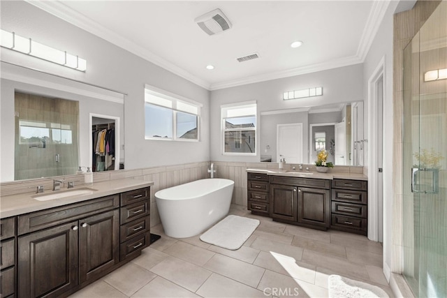 bathroom featuring plus walk in shower, tile patterned floors, vanity, and crown molding