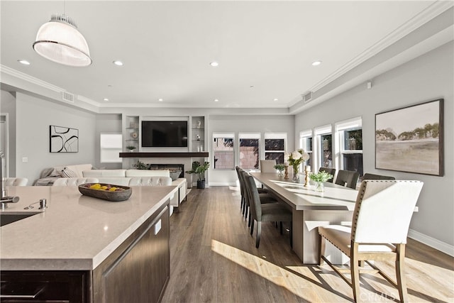 dining room with crown molding and dark hardwood / wood-style flooring