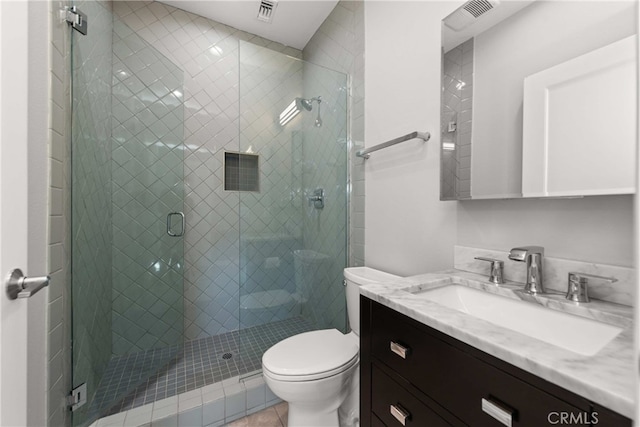 bathroom with walk in shower, vanity, and toilet