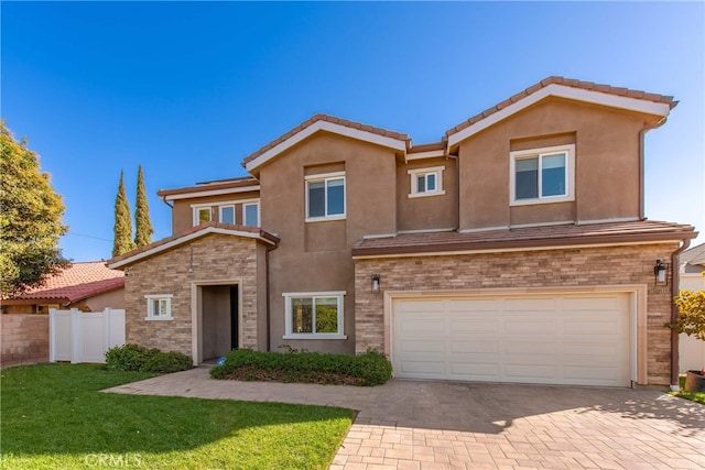 view of front of home featuring a garage and a front lawn