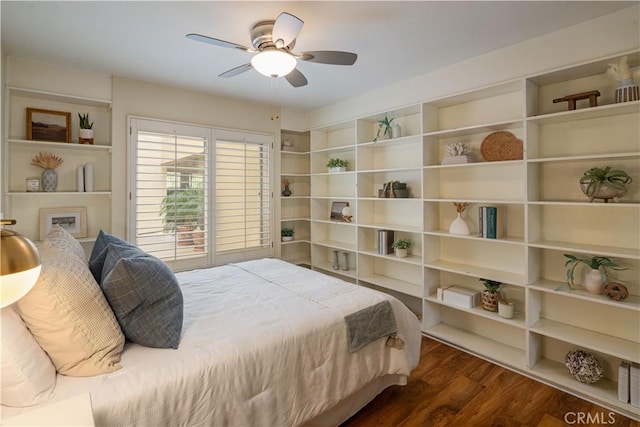 bedroom with ceiling fan and dark hardwood / wood-style flooring