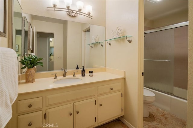 full bathroom featuring vanity, toilet, and combined bath / shower with glass door