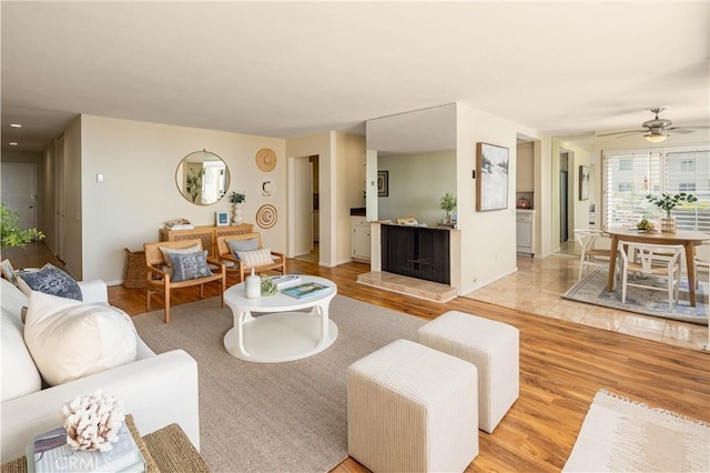 living room featuring ceiling fan and light wood-type flooring