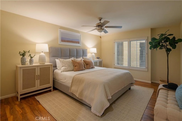 bedroom featuring dark hardwood / wood-style floors and ceiling fan