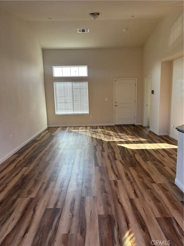 unfurnished room with dark hardwood / wood-style floors