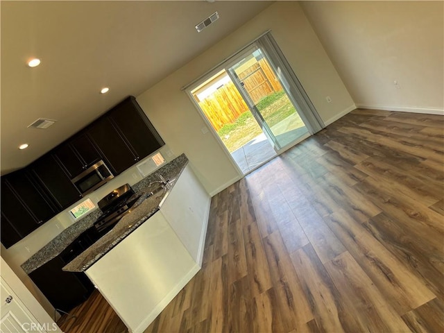 unfurnished living room featuring dark wood-type flooring