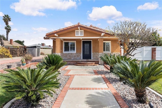 view of front of property with a storage shed