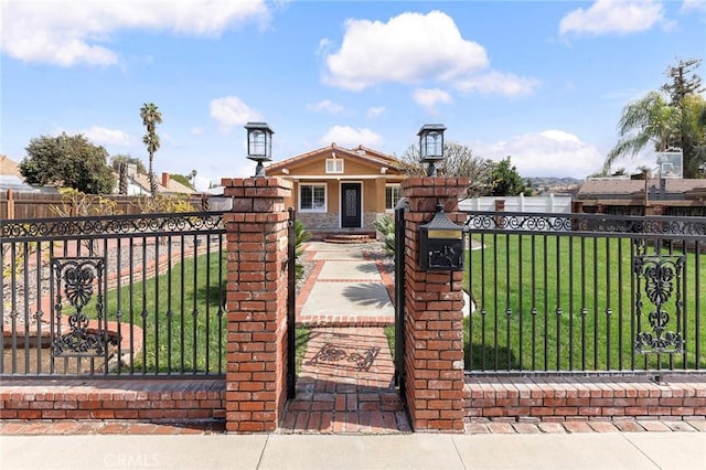 view of gate with a yard