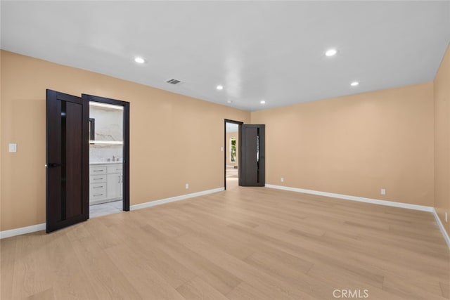 unfurnished room with light wood-type flooring