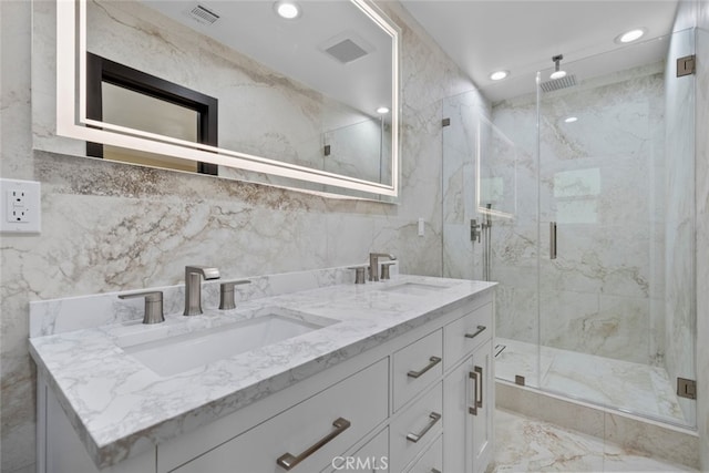 bathroom with vanity and a shower with shower door