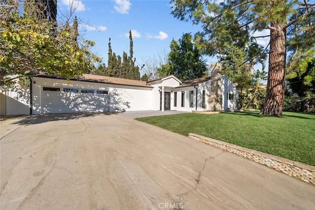 ranch-style house with a garage and a front yard