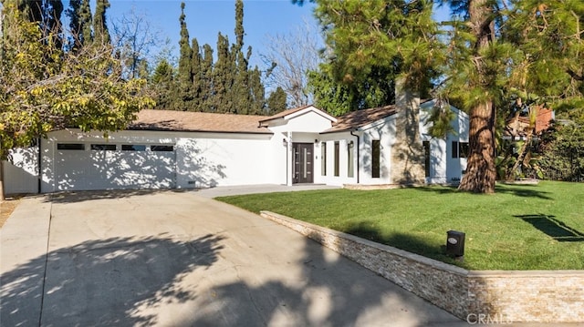 single story home with a garage and a front lawn