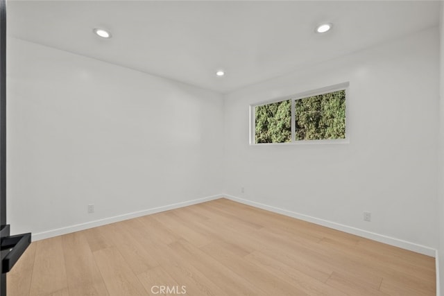 spare room featuring light hardwood / wood-style floors