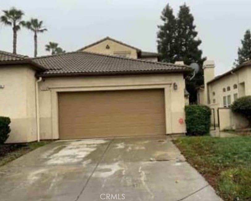 mediterranean / spanish-style house featuring a garage