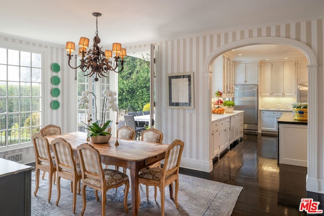 dining space with an inviting chandelier and dark wood-type flooring