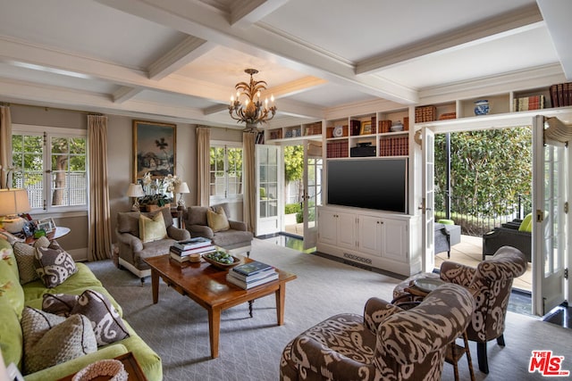 carpeted living room with beam ceiling, a chandelier, and a wealth of natural light