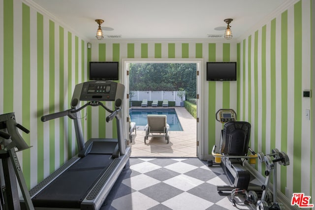 exercise room featuring ornamental molding