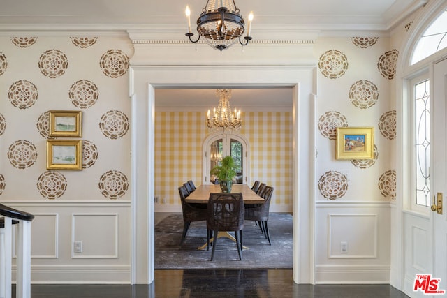 dining area with dark hardwood / wood-style flooring, crown molding, and a chandelier