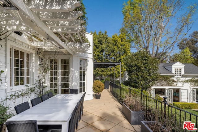 view of patio / terrace featuring french doors and a pergola