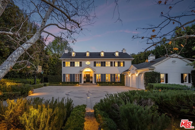 colonial inspired home featuring a garage