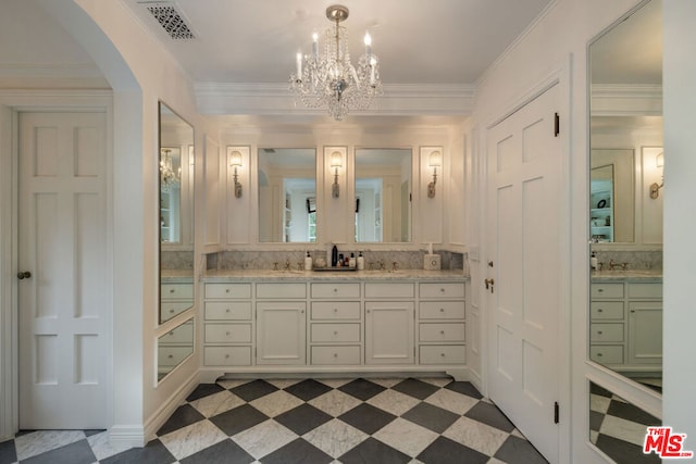 bathroom featuring crown molding, vanity, and a chandelier