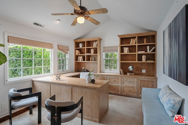 office with lofted ceiling, a wealth of natural light, light colored carpet, and ceiling fan