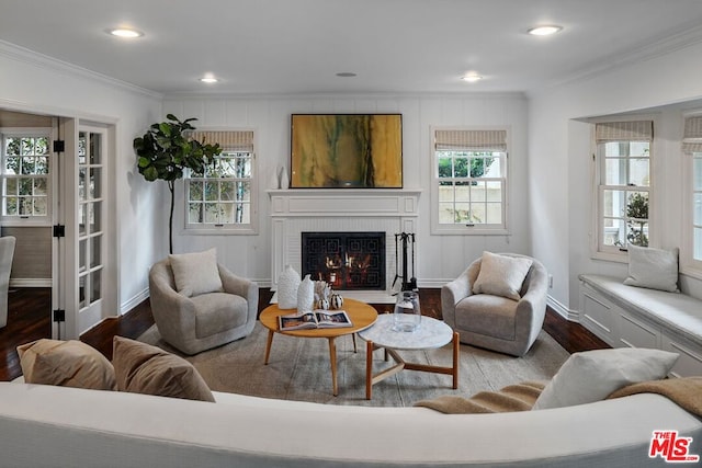 living room with crown molding, a healthy amount of sunlight, and hardwood / wood-style flooring