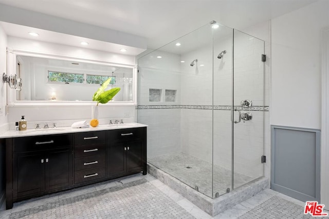 bathroom featuring vanity and a shower with door