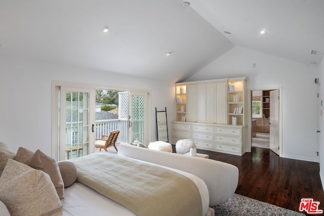 bedroom with ensuite bathroom, lofted ceiling, dark hardwood / wood-style floors, and access to exterior