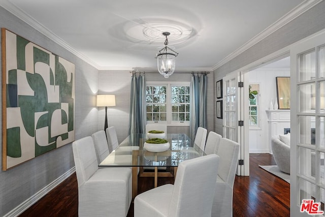 dining space featuring crown molding, dark hardwood / wood-style floors, and a notable chandelier