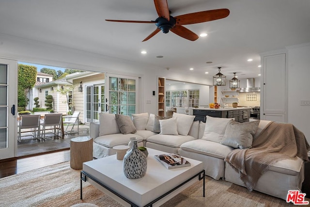 living room featuring light hardwood / wood-style flooring and ceiling fan