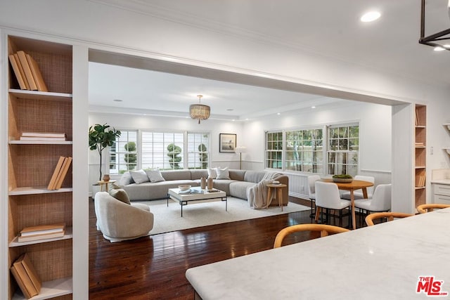 living room with crown molding and dark hardwood / wood-style flooring