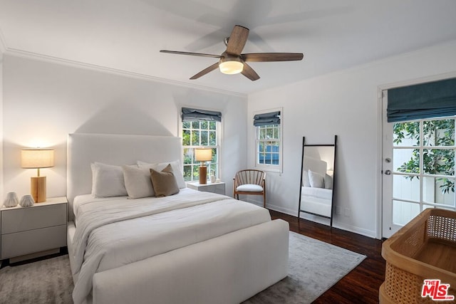 bedroom with ornamental molding, dark hardwood / wood-style floors, and ceiling fan