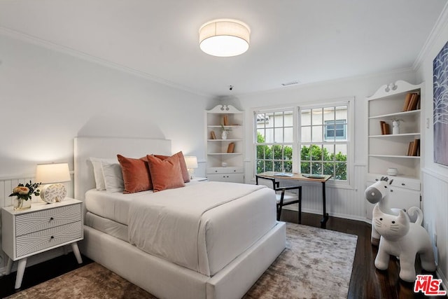 bedroom featuring ornamental molding and dark hardwood / wood-style floors