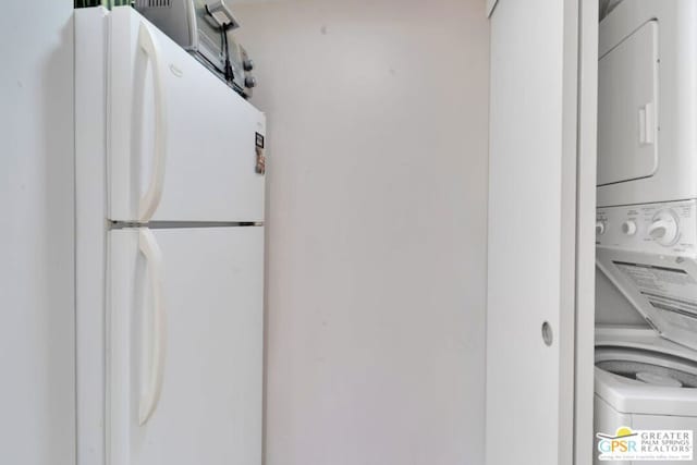 room details with stacked washing maching and dryer and white refrigerator