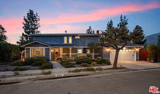 view of front of property featuring a garage and a mountain view