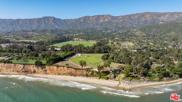 birds eye view of property featuring a water and mountain view and a beach view