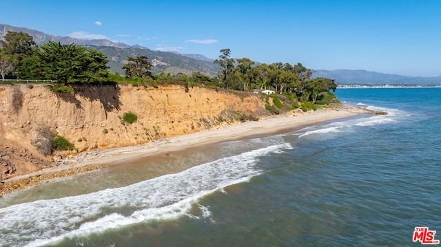 bird's eye view with a beach view and a water and mountain view