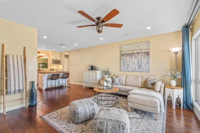 living room featuring dark hardwood / wood-style floors and ceiling fan