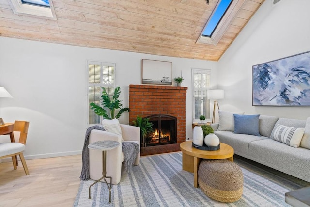 living room featuring wood ceiling, a fireplace, lofted ceiling with skylight, and light wood-type flooring