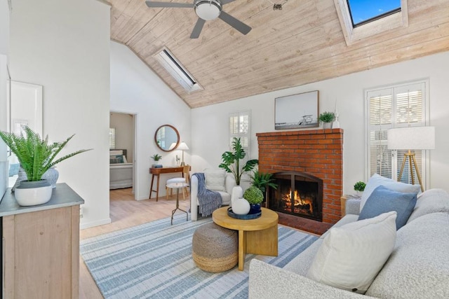 living room featuring a brick fireplace, a skylight, wooden ceiling, and plenty of natural light