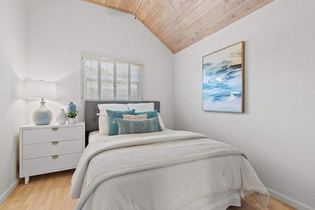 bedroom with lofted ceiling, wood ceiling, and light hardwood / wood-style flooring