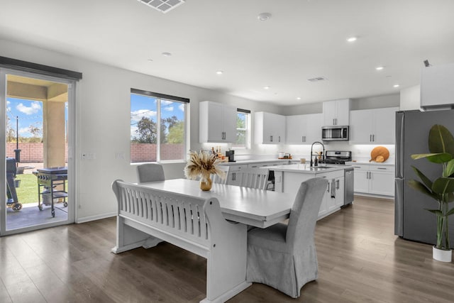 dining space with dark hardwood / wood-style floors and sink