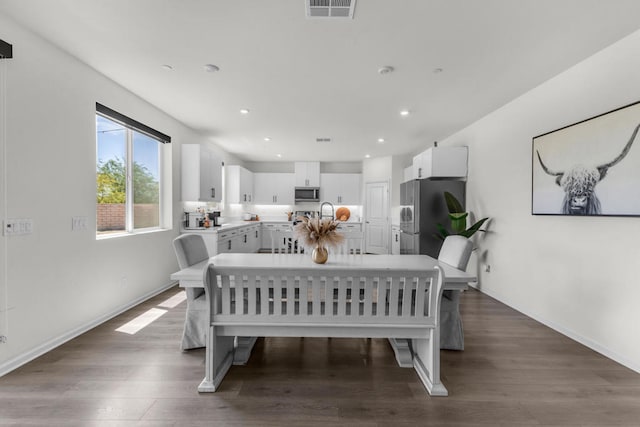 dining area featuring dark hardwood / wood-style flooring