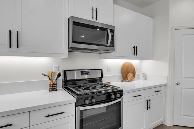 kitchen with appliances with stainless steel finishes and white cabinets