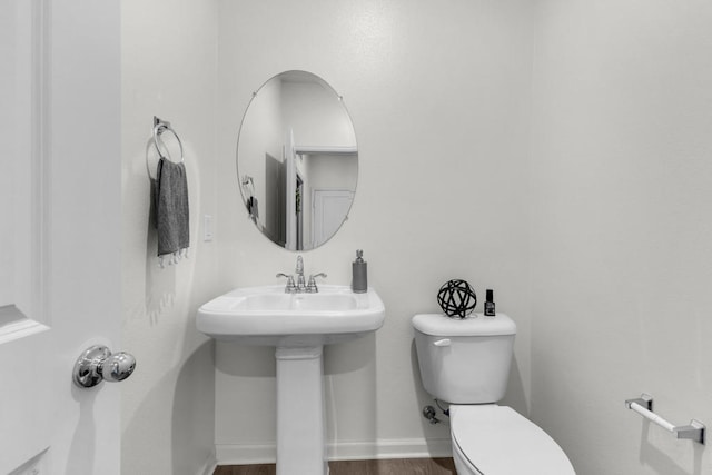 bathroom with sink, wood-type flooring, and toilet