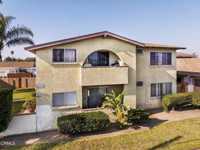 exterior space featuring a front yard and a balcony