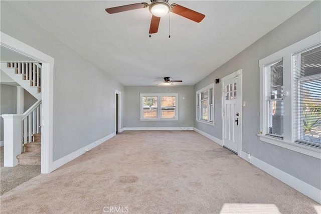 interior space featuring ceiling fan and light colored carpet