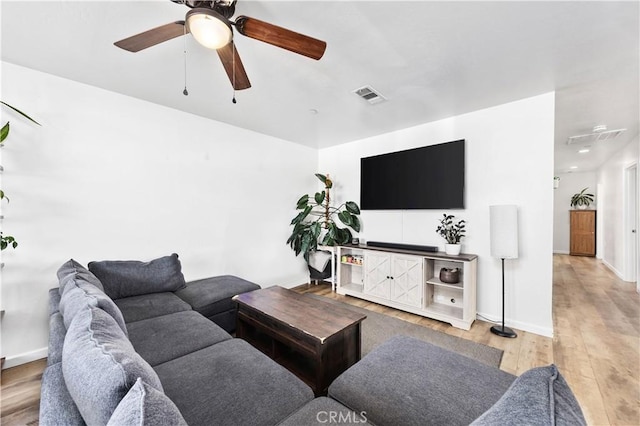 living room with ceiling fan and light hardwood / wood-style floors